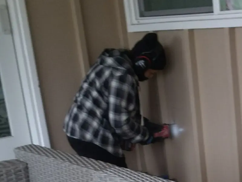 Professional electrician installing an exterior outlet in Peralta